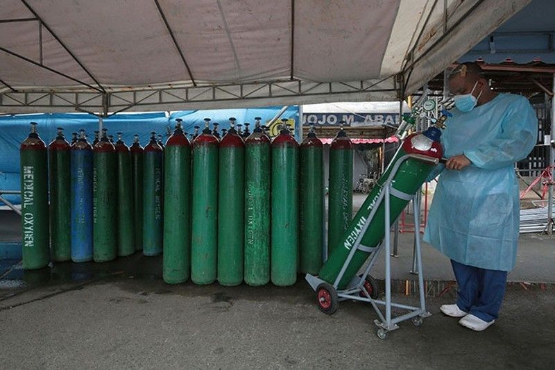 A health worker checks the medical oxygen tanks at Rosario Maclang Bautista Hospital in Quezon City on Aug. 27 2021. (Photo / Retrieved from Philstar)